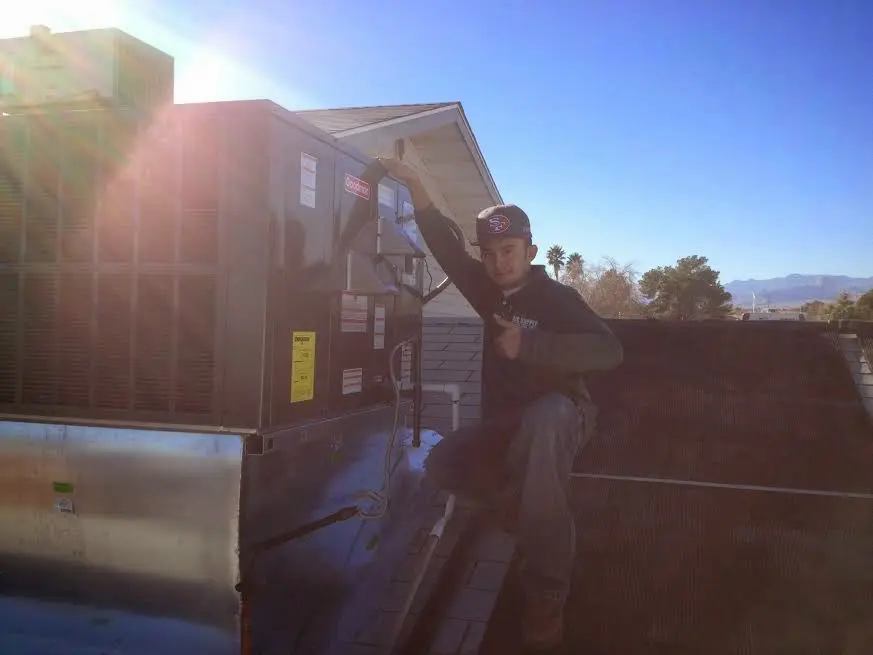 HVAC technician performing HVAC Inspection on a rooftop unit in Kirkland